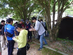 Students stamp the participants next to the hot spring source.