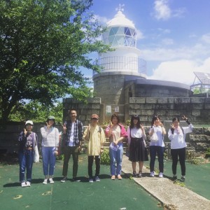 Group photo in front of Rokurenjima Lighthouse, a Japanese heritage site